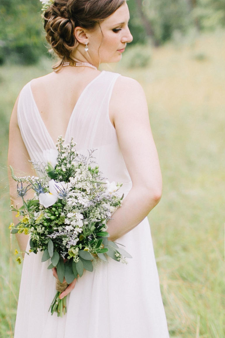 bride holding wildflower bouquet