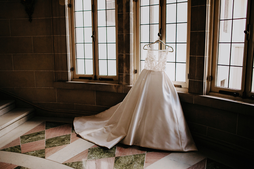 wedding dress hanging near window at armour house