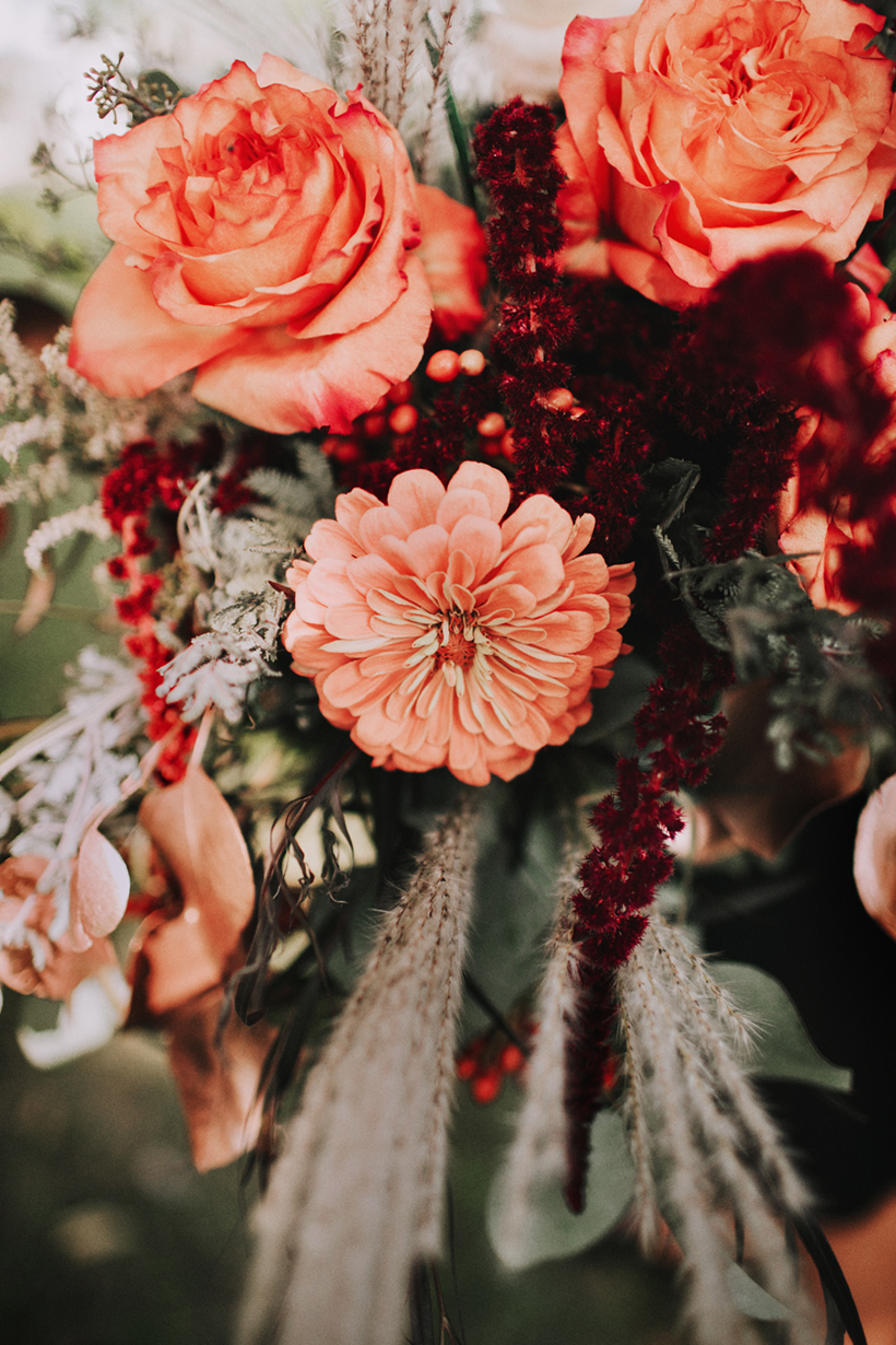 summery wedding bouquet with orange and coral zinnias