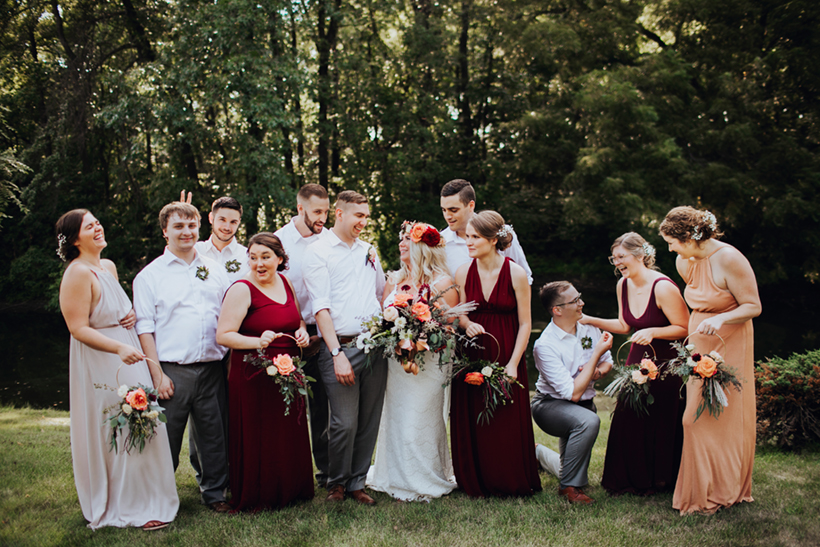 mismatched boho bridal party dresses with floral hoops for the bridesmaids