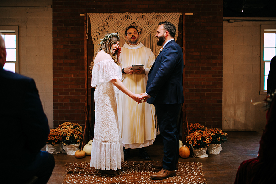 a bohemian wedding ceremony indoors at camp wokanda in Peoria Illinois