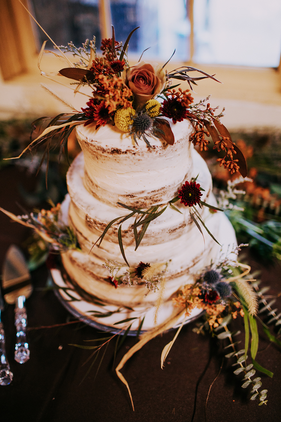 a wedding crumb cake decorated with autumn leaves