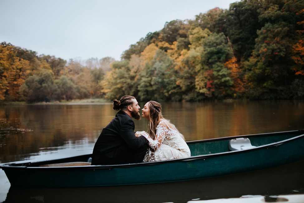 bride and groom in canoe in autumn