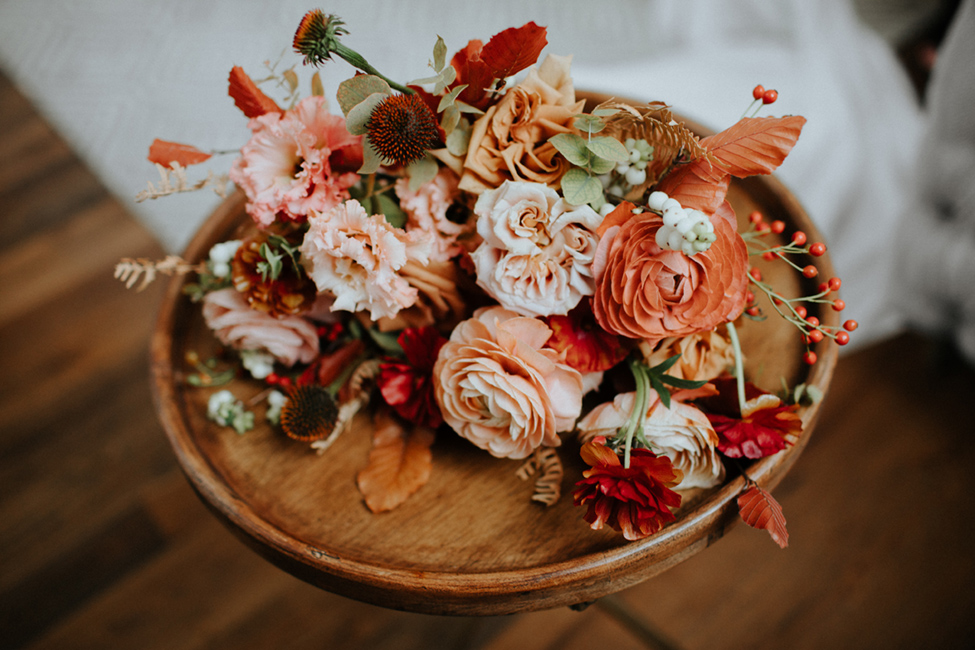 autumn wedding bouquet with rust and peach and berries
