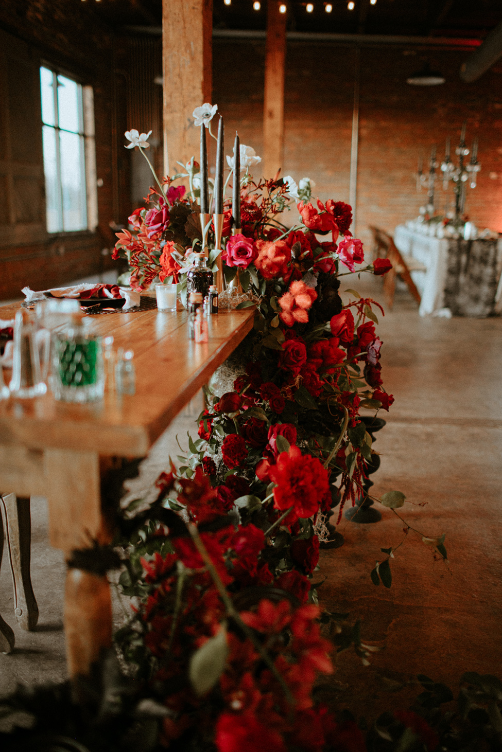 burgundy jewel tone cascading wedding flowers at ceremony or reception