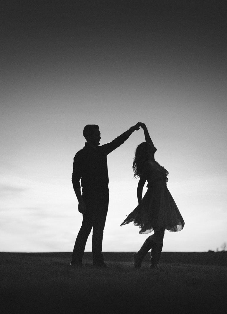 black and white silhouette of couple dancing in field peoria il engagement session